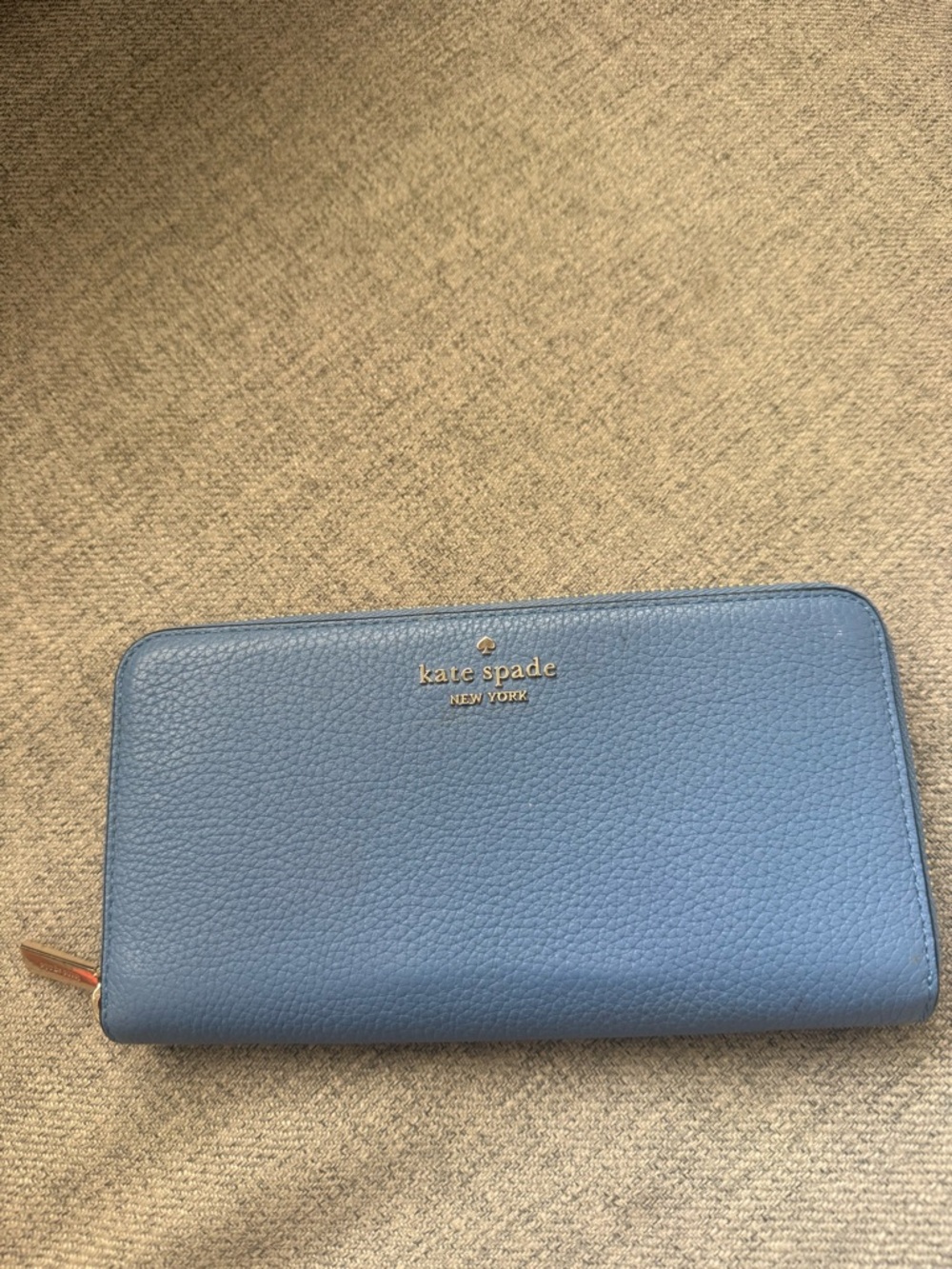 kate spade blue pebbled zip-around wallet with gold logo